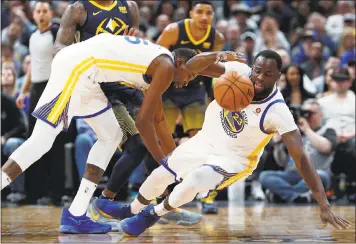  ?? DAVID ZALUBOWSKI — THE ASSOCIATED PRESS ?? Even with stars such as Draymond Green, right, and Kevin Durant, the Warriors were 26th in defensive rating last month.