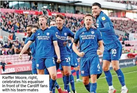  ?? ?? Kieffer Moore, right, celebrates his equaliser in front of the Cardiff fans with his team-mates