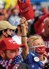  ?? Melissa Sue Gerrits / Getty Images ?? Supporters react to President Donald Trump’s arrival Thursday for a rally at the airport in Greenville, N.C. Thousands gathered to hear him speak.