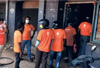  ??  ?? SWIGGY DELIVERY PERSONNEL waiting at the Koyambedu market in Chennai on April 10 to pick up vegetables for delivery. The government could make it easier for such platform workers by setting platform policy.