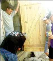  ?? COURTESY PHOTO ?? Members of Prairie Grove Christian Church built this door and installed it for a family in Haiti. The church sent a 15-member mission team to Haiti in December to help at an orphanage and a school run by Hope for Haiti.