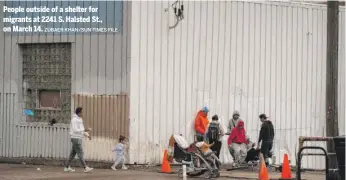  ?? ZUBAER KHAN/SUN-TIMES FILE ?? People outside of a shelter for migrants at 2241 S. Halsted St., on March 14.