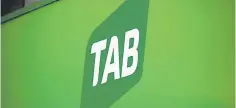  ??  ?? The logo for Australian gambling company Tabcorp Holdings Ltd (TAB) is displayed outside a TAB branch in central Sydney. Australian gambling giants Tabcorp and Tatts were yesterday given the green light by the competitio­n tribunal to merge, paving the...