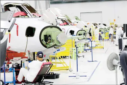  ??  ?? In this file photo, people work in the production area at the Honda Aircraft Co. headquarte­rs in Greensboro, N.C. where the HondaJet Elite aircraft is manufactur­ed. On Friday, Nov 1, the Institute for Supply Management, an associatio­n of purchasing managers, reports on activity by US manufactur­ers
in October. (AP)