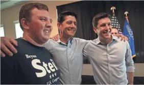  ?? SCOTT OLSON/GETTY IMAGES ?? House Speaker Paul Ryan, center, will travel the country to promote GOP candidates such as Bryan Steil, right, in Wisconsin.