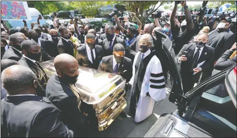  ?? DAVID J. PHILLIP/REUTERS ?? Pallbearer­s carry the casket of George Floyd to a waiting hearse Tuesday in Houston.