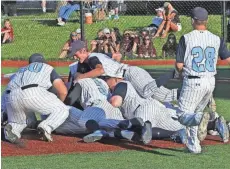  ?? JOHN KLEIN / FOR THE JOURNAL SENTINEL ?? West Bend West players pile on each other after the Spartans beat Menomonee Falls, 7-2, in the Whitefish Bay sectional final on Monday to earn a bid to the WIAA state summer baseball tournament.