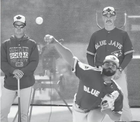  ?? NATHAN DENETTE/THE CANADIAN PRESS ?? New Toronto Blue Jays manager Charlie Montoyo and pitching coach Pete Walker watch Hector Perez work out as the team kicks off spring training this week in Dunedin, Fla. The Jays will trot out a young lineup this season with several veterans having moved on.