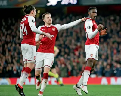  ?? AP ?? Danny Welbeck (right) celebrates with his teammates Aaron Ramsey and Hector Bellerin after scoring a goal against AC Milan. —