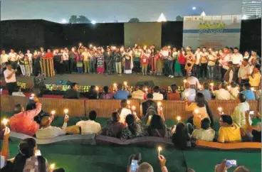  ?? SOURCED ?? The audience holds candles at a performanc­e in CP’S Central Park. Social issues such as farmers’ suicide are themes for the event.