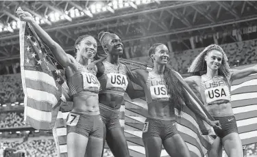  ?? Doug Mills / New York Times ?? Allyson Felix, from left, Athing Mu, Dalilah Muhammed and Sydney McLaughlin celebrate their win.