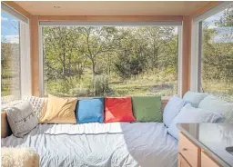  ??  ?? Wall-size windows in this 180-square-foot house ‘make it seem like you’re in the middle of nature,’ said Seth Porges, the owner.