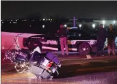  ?? STETSON PAYNE — TULSA WORLD VIA AP ?? Emergency personnel respond to a crash involving multiple vehicles and a police officer who was on foot in icy conditions in Catoosa, Okla., Thursday.