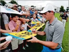  ?? CHRIS CARLSON/AP PHOTO ?? Rory McIlroy signs autographs after a practice round at the PGA Championsh­ip on Tuesday at Charlotte, N.C.