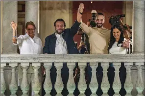  ?? (AP/Moises Castillo) ?? El Salvador President Nayib Bukele (second from right), his wife, Gabriela Rodriguez (right), running mate and Vice President Felix Ulloa (second from left), and his wife, Lilian Alvarenga, wave to supporters from the balcony of the presidenti­al palace after general election polls closed in San Salvador, El Salvador, late Sunday.