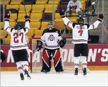  ?? SHARI L. GROSS/STAR TRIBUNE VIA AP ?? Ohio State forward Paetyn Levis (27) and defenseman Emma Peschel (7) skate toward goaltender Amanda Thiele (30) as time runs out in a national semifinal against Northeaste­rn in the women’s NCAA Frozen Four college hockey tournament in Duluth, Minn., Friday, March 17, 2023.