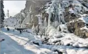  ?? ANI ?? People enjoy near a frozen waterfall at the Drang area in Srinagar on Sunday