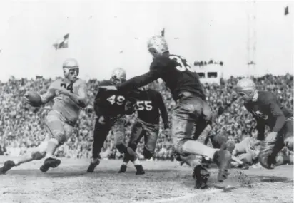  ?? Courtesy of the Cotton Bowl ?? DITOR’S NOTE: Last in five-part series profiling Colorado football icons. Floyd Little, Darian Hagan, Andy Lowry and Sonny Lubick were previously profiled.
Byron “Whizzer” White, left, carries the ball for the University of Colorado in the 1938 Cotton Bowl against Rice. White led the Buffs to an undefeated 1937 season, but CU lost the bowl game 28-14.