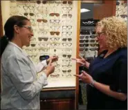  ?? DONNA ROVINS — DIGITAL FIRST MEDIA ?? Complete Family Eyecare, in Swamp Pike in New Hanover, offers patients an estimated 1,000 eyeglass frames from which to choose. In this photo optometris­t Dr. Lori Gray, left, talks with staff member Janie Miuccio in the optical department.