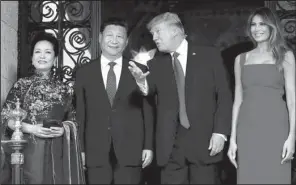  ?? AP/ ALEX BRANDON ?? President Donald Trump talks with Chinese President Xi Jinping as they pose with fi rst lady Melania Trump and Xi’s wife Peng Liyuan before dinner Thursday at the Mar- a- Lago resort in Palm Beach, Fla.