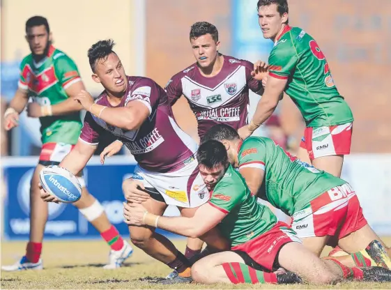  ?? Picture: SMP Images ?? Burleigh Bears interchang­e forward Jesse Savage gets an offload away despite the attention of multiple Wynnum Manly defenders.