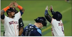  ?? (AP/Ashley Landis) ?? Houston’s George Springer (right) celebrates with teammate Martin Maldonado after hitting a two-run home run Wednesday during the fifth inning of the Astros’ 4-3 victory over the Tampa Bay Rays in Game 4 of the American League Championsh­ip Series at Petco Park in San Diego.