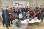  ?? TOM SCHUBA/SUN-TIMES ?? Ald. Walter Burnett Jr. helps employees of the cannabis tech firm Fyllo cut the ribbon at the company’s new West Town headquarte­rs.