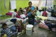  ?? RODRIGO ABD - THE ASSOCIATED PRESS ?? Survivors of the Volcan de Fuego, or “Volcano of Fire” eruption, gather at a shelter in Alotenago, Guatemala, Thursday. Guatemalan prosecutor­s ordered an investigat­ion into whether emergency protocols were followed properly, as many residents were caught by the eruption with little or no time to evacuate.