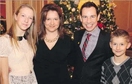  ?? PHOTOS: CAROLINE PHILLIPS/ OTTAWA CITIZEN ?? Alex Munter, CEO of the Children’s Hospital of Eastern Ontario, second from right, pauses for a photo Monday at the Trees of Hope, a fundraiser for CHEO, with organizer Deneen Perrin and her children, Sophia Michel, 14, and Alex Michel, 10, who is also...