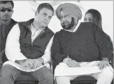  ?? AP PHOTO ?? Congress party Vice President Rahul Gandhi, left, speaks with former chief minister of Punjab state Amarinder Singh during an election campaign rally in Amritsar, India The Punjab state will go to the polls on Feb. 4.