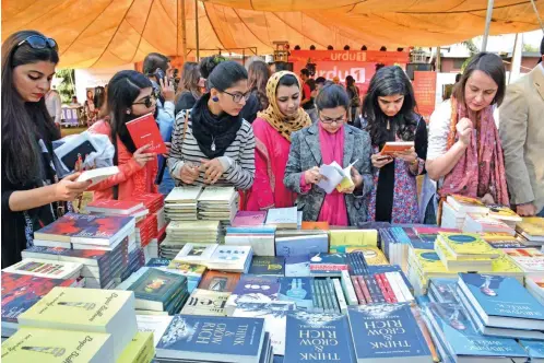  ?? — AFP ?? Women are seen browsing books at the Lahore Literary Festival in Lahore on Saturday in this picture released on Monday. Pakistan’s literary scene is seeing a spirited revival with packed festivals attracting tens of thousands defying security threats...