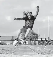  ?? MATIAS J. OCNER mocner@miamiheral­d.com ?? Emani Perry, 17, a member of the Miami Northweste­rn track and field team, practices her long jump.