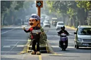  ??  ?? A dummy of Delhi Chief Minister Arvind Kejriwal promotes the odd-even scheme on the streets of the capital.