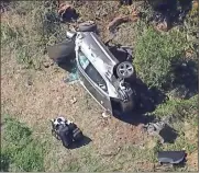  ?? AP ?? In an aerial image taken from video provided by KABC-TV, a vehicle driven by Tiger Woods rests on its side after a rollover crash Tuesday in Los Angeles.