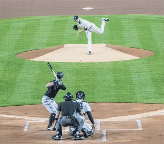  ?? Corey Sipkin / Associated Press ?? Yankees pitcher J.A. Happ pitches to Miami’s Jon Berti in the first inning. Happ gave up three runs in the inning, but nothing more through the fifth.