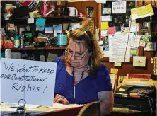  ?? Tracy Barbutes / Contributo­r ?? Robbie Nelson’s Airport Bar & Grill in Mariposa, Calif., defies state regulation­s Dec. 9, with few customers wearing masks.