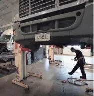  ??  ?? Truck mechanic Brandon Lee works on a big rig at TAG's new sales, service and training campus located on the former Mall of Memphis site. JIM WEBER/THE COMMERCIAL APPEAL