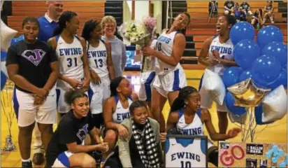  ?? KYLE FRANKO/ TRENTONIAN PHOTO ?? Ewing High senior Mya Grimes (10) poses with teammates on the court after she scored her 1,000th career point in Friday night’s season-opening win against Hightstown.