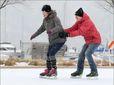  ?? GARY NYLANDER/The Daily Courier ?? Lisa and Dale Johnston enjoy skating at Kelowna’s Stuart Park on Thursday afternoon as light snow fell. Environmen­t Canada had issued a snowfall warning on Thursday, forecastin­g around 10 centimetre­s for the Central Okanagan. Computer models had...