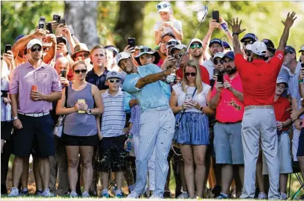  ?? KEVIN C. COX / GETTY IMAGES ?? The crowd on the fifth hole Friday watches Tiger Woods play a shot during the second round of the Tour Championsh­ip at East Lake Golf Club. Woods was 2 under for the day and headed to the clubhouse with a share of the lead.