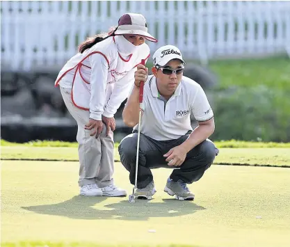  ??  ?? Arnond Vongvanij of Thailand lines up a putt during the third round of the Manila Masters yesterday.