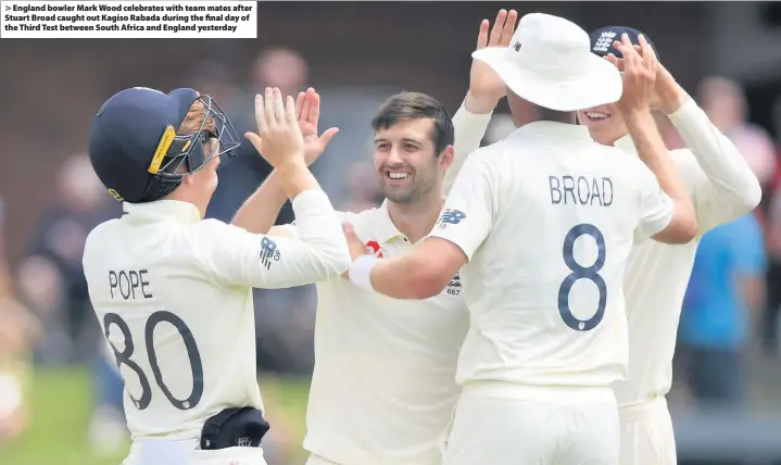  ??  ?? > England bowler Mark Wood celebrates with team mates after Stuart Broad caught out Kagiso Rabada during the final day of the Third Test between South Africa and England yesterday