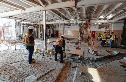  ?? Steve Gonzales / Houston Chronicle file ?? Constructi­on workers finish an addition to Waltrip High School, which received $30 million worth of upgrades from a 2012 bond, in 2015. Voters in Houston ISD now could be asked to approve a bond possibly totaling $1.2 billion.