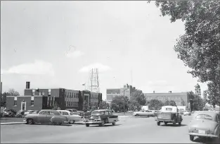  ?? Galt Archives photo 1976001100­0-014 ?? Lethbridge City Hall, at left, located on 4 Avenue South between 9 and10 Streets, is shown in 1955.