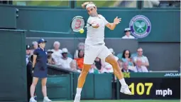  ??  ?? GETTY IMAGES Roger Federer hits a forehand shot during his fourth-round victory over France's Adrian Mannarino at Wimbledon in All England Lawn Tennis and Croquet Club in London, Britain, on July 9, 2018.