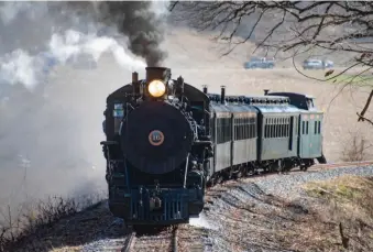  ?? ?? No. 16 leads a train with three coaches, a new combine with wheelchair lifts, and caboose.