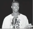  ?? THE ASSOCIATED PRESS FILE ?? In this Dec. 30, 1959, file photo, Cincinnati’s Oscar Robertson poses with the MVP award after leading his team to the ECAC Holiday Festival Championsh­ip.