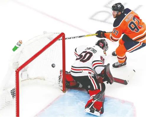  ?? JEFF VINICK / GETTY IMAGES ?? Connor Mcdavid scores his second goal of the night Monday, putting the puck past Corey Crawford
after a rush that was pure magic as he skated down the ice controllin­g a bouncing puck.