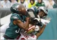  ?? CHRIS SZAGOLA — THE ASSOCIATED PRESS ?? Philadelph­ia Eagles’ Rasul Douglas (32) and Alshon Jeffery (17) break up a pass intended for San Francisco 49ers’ Kendrick Bourne (10) during the first half of an NFL football game, Sunday in Philadelph­ia,.