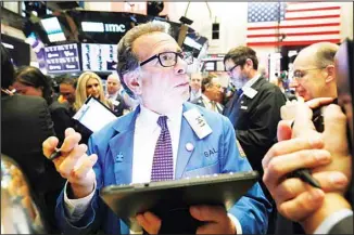  ??  ?? In this file photo trader Sal Suarino works on the floor of the New York Stock Exchange. (AP)